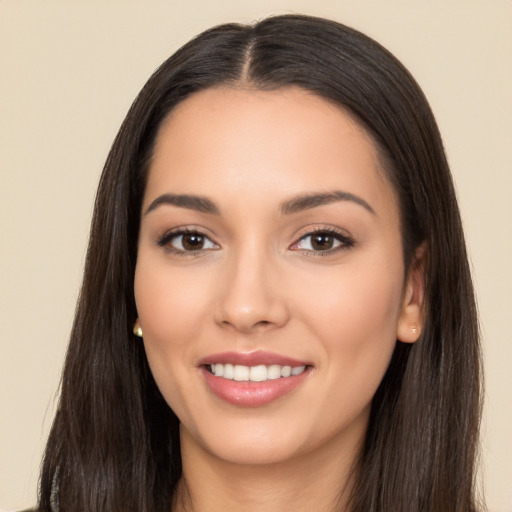 Joyful white young-adult female with long  black hair and brown eyes