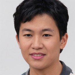 Joyful asian young-adult male with short  brown hair and brown eyes