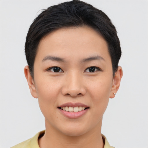 Joyful asian young-adult female with short  brown hair and brown eyes