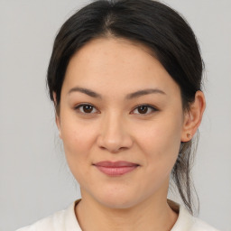 Joyful asian young-adult female with medium  brown hair and brown eyes