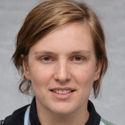 Joyful white young-adult female with medium  brown hair and blue eyes