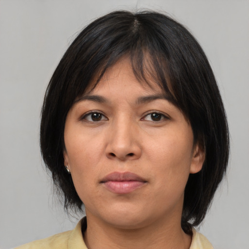 Neutral asian adult female with medium  brown hair and brown eyes