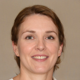 Joyful white adult female with medium  brown hair and brown eyes