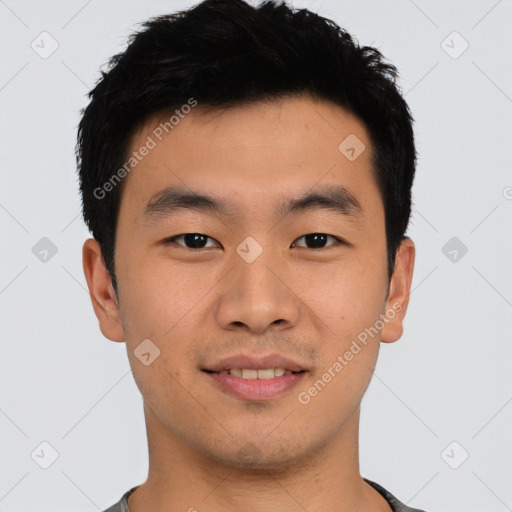 Joyful asian young-adult male with short  black hair and brown eyes