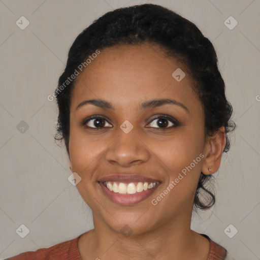 Joyful black young-adult female with medium  black hair and brown eyes