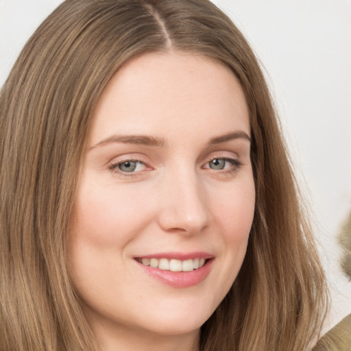 Joyful white young-adult female with long  brown hair and grey eyes