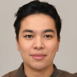 Joyful asian young-adult male with short  brown hair and brown eyes