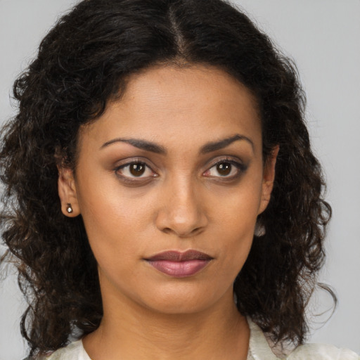 Joyful black young-adult female with medium  brown hair and brown eyes