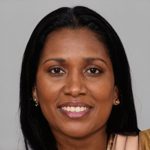 Joyful black young-adult female with long  brown hair and brown eyes