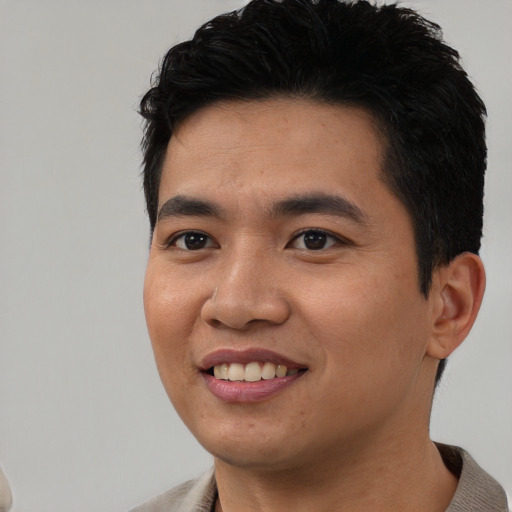 Joyful asian young-adult male with short  black hair and brown eyes