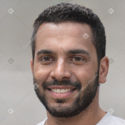 Joyful white young-adult male with short  black hair and brown eyes