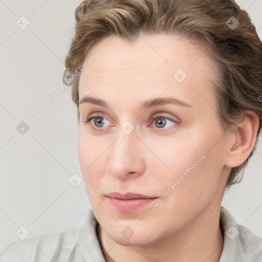 Joyful white young-adult female with short  brown hair and blue eyes