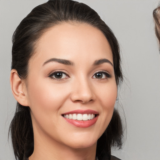 Joyful white young-adult female with medium  brown hair and brown eyes