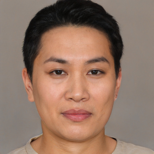 Joyful asian young-adult female with short  black hair and brown eyes