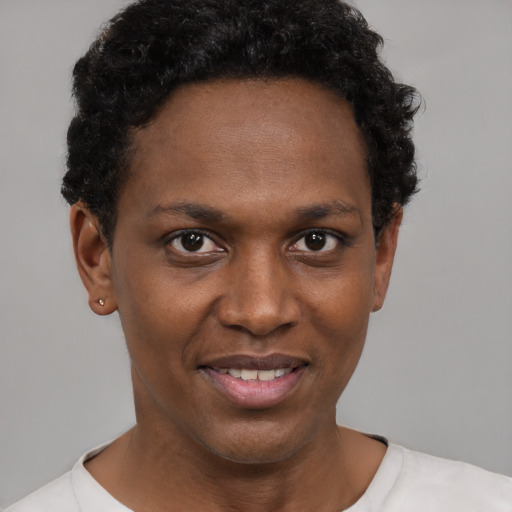 Joyful black young-adult female with short  black hair and brown eyes