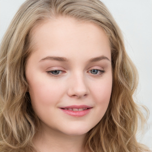 Joyful white young-adult female with long  brown hair and blue eyes