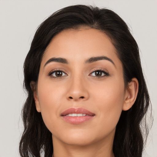 Joyful white young-adult female with long  brown hair and brown eyes