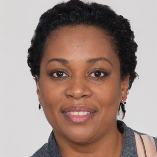 Joyful black adult female with short  black hair and brown eyes
