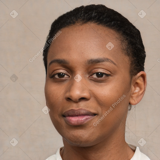 Joyful black young-adult female with short  black hair and brown eyes