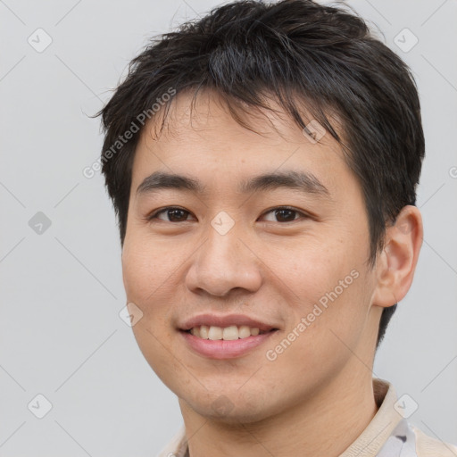 Joyful asian young-adult male with short  brown hair and brown eyes