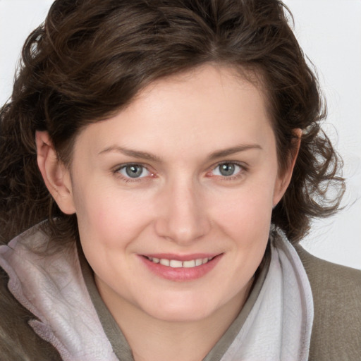 Joyful white young-adult female with medium  brown hair and blue eyes