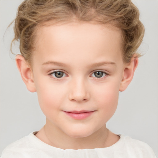 Joyful white child female with short  brown hair and grey eyes