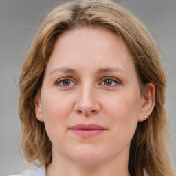 Joyful white young-adult female with medium  brown hair and blue eyes