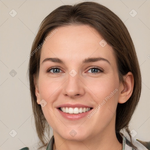 Joyful white young-adult female with medium  brown hair and grey eyes