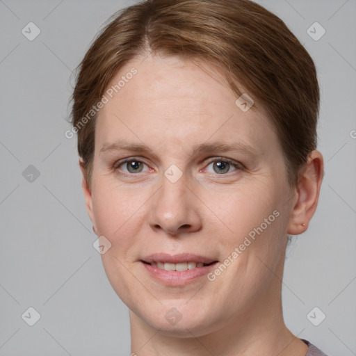 Joyful white adult female with short  brown hair and grey eyes