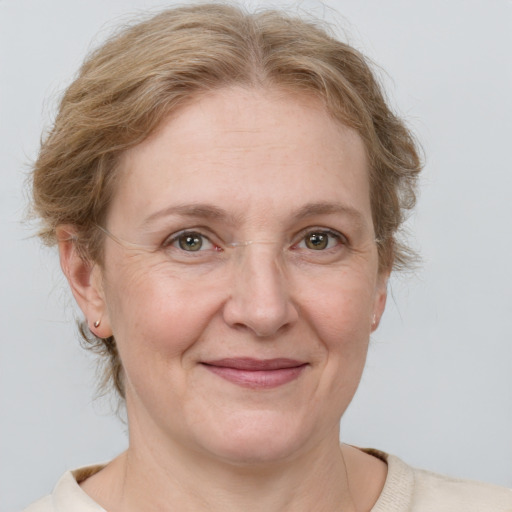 Joyful white adult female with medium  brown hair and blue eyes