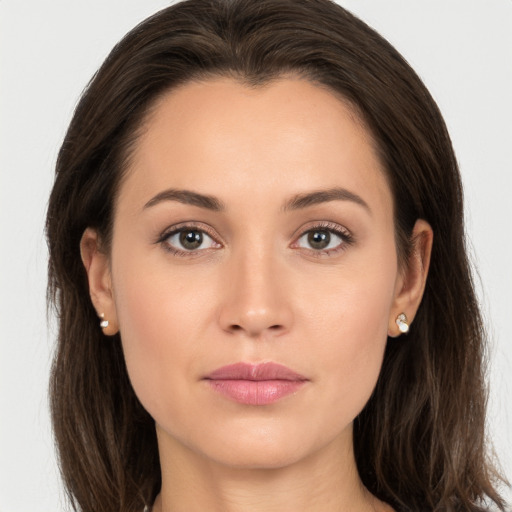 Joyful white young-adult female with long  brown hair and brown eyes