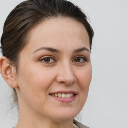 Joyful white young-adult female with medium  brown hair and brown eyes