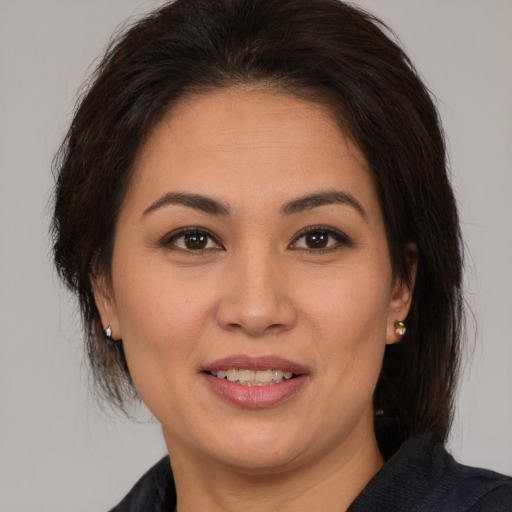Joyful white adult female with medium  brown hair and brown eyes