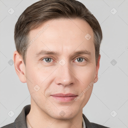 Joyful white young-adult male with short  brown hair and grey eyes