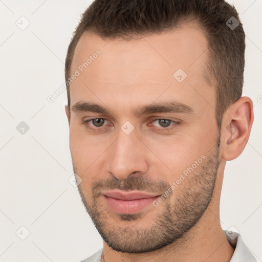 Joyful white young-adult male with short  brown hair and brown eyes