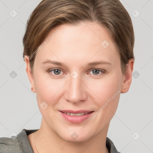 Joyful white young-adult female with short  brown hair and grey eyes