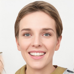 Joyful white young-adult female with medium  brown hair and green eyes