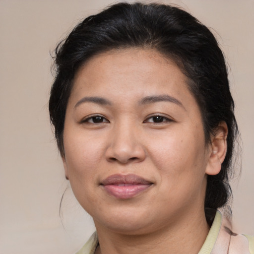 Joyful asian adult female with medium  brown hair and brown eyes