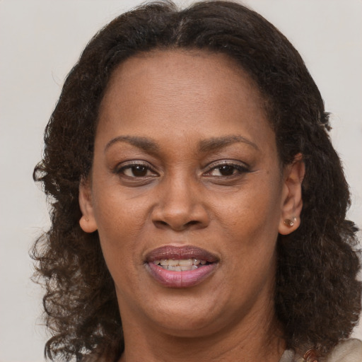 Joyful black adult female with medium  brown hair and brown eyes