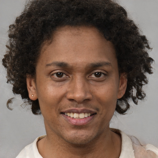 Joyful black adult female with short  brown hair and brown eyes