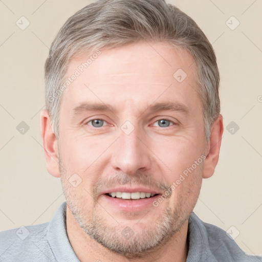 Joyful white adult male with short  brown hair and grey eyes