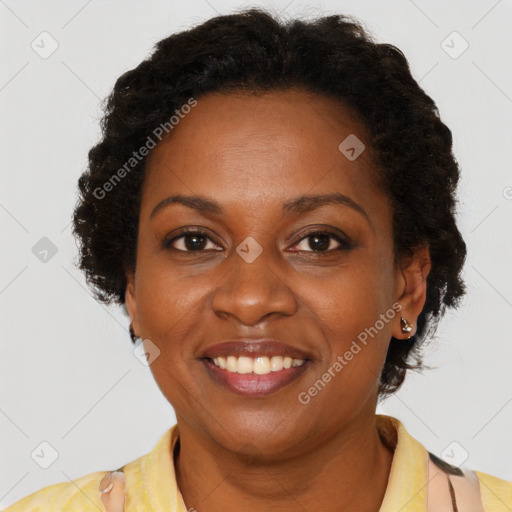 Joyful black adult female with short  brown hair and brown eyes