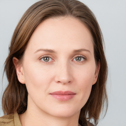 Joyful white young-adult female with medium  brown hair and grey eyes