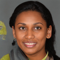 Joyful latino young-adult female with short  black hair and brown eyes
