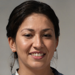 Joyful white adult female with medium  brown hair and brown eyes