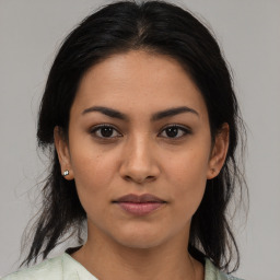 Joyful latino young-adult female with medium  brown hair and brown eyes