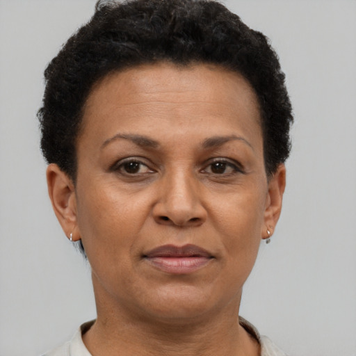 Joyful black adult female with short  brown hair and brown eyes