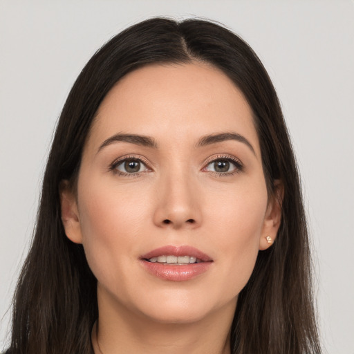 Joyful white young-adult female with long  brown hair and brown eyes