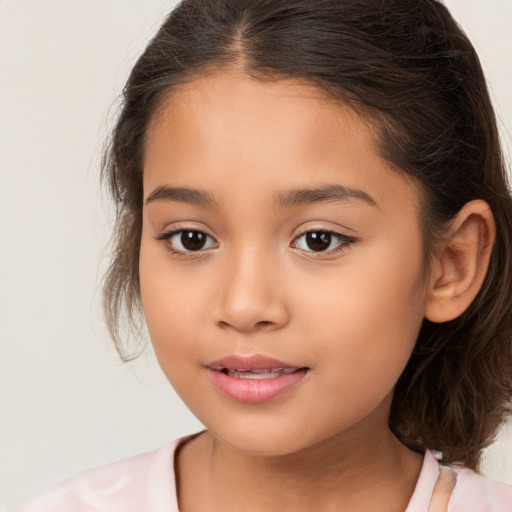 Joyful white child female with medium  brown hair and brown eyes