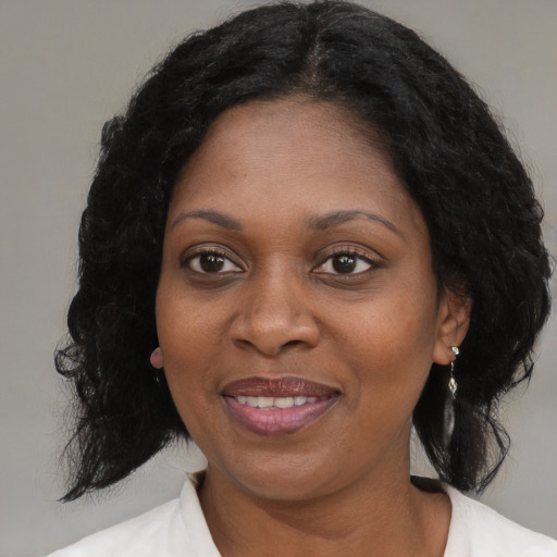 Joyful black adult female with medium  black hair and brown eyes